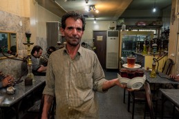 Iranian man serves tea in Shisha bar